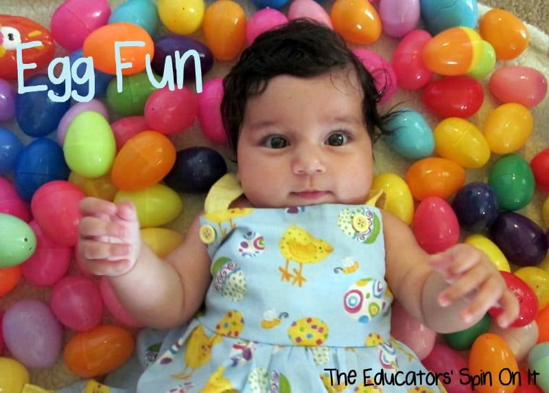 baby laying in easter eggs for sensory play