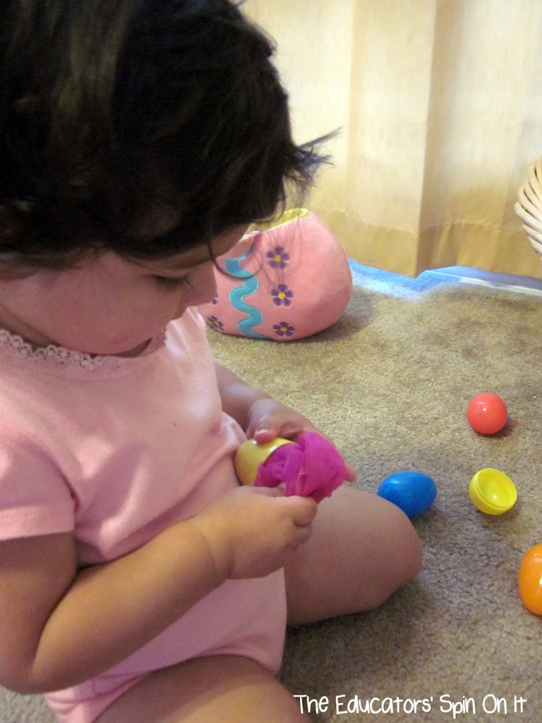 Toddler playing with easter eggs 