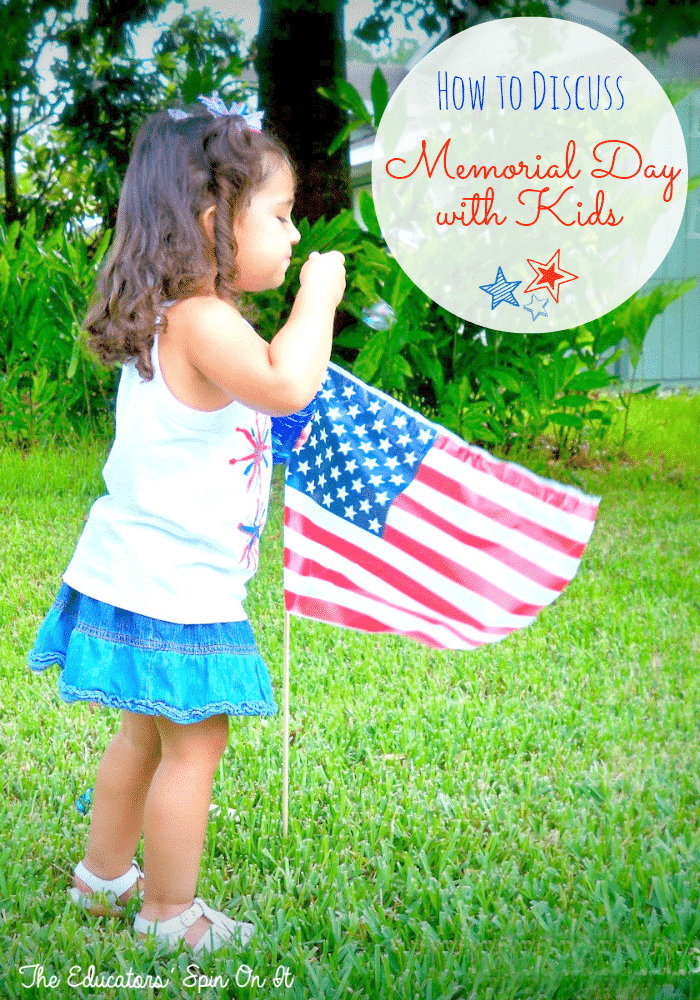 Child blowing bubbles near flag in honor of Memorial Day