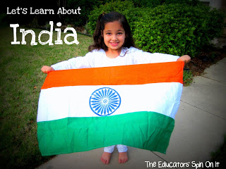 Young girl in white indian clothes holding India flag.