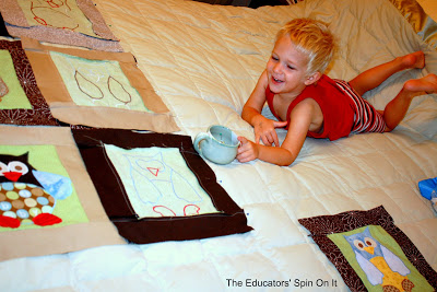 Child helping to make owl quilt for new baby