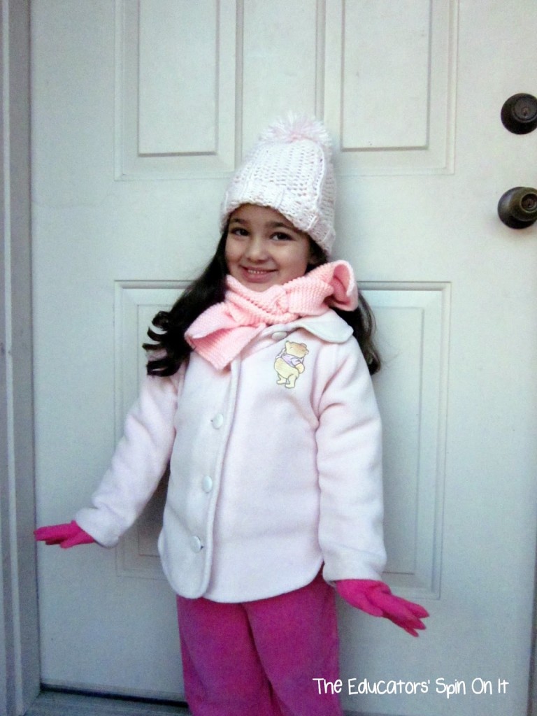 Learning about Winter Clothes with kids, a child in pink winter jacket with scarf and gloves. 