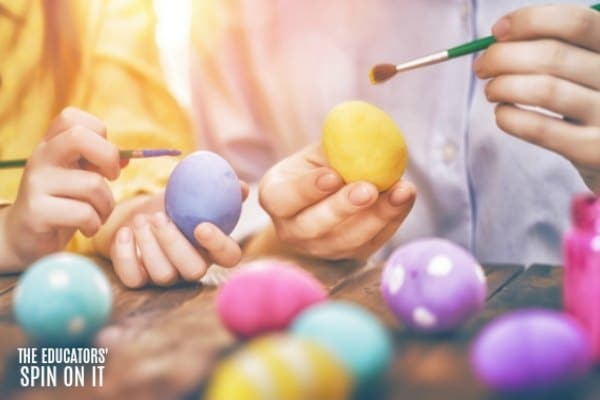 painting yellow, purple, pink and turquoise eggs with kids for easter