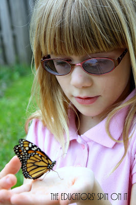 child holding monarch butterfly