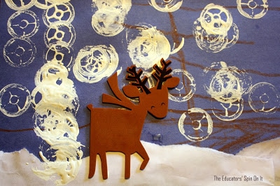 Reindeer art with spool snowflakes on blue paper