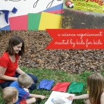 Kids creating ladybug science experiment outdoors on various colored papers