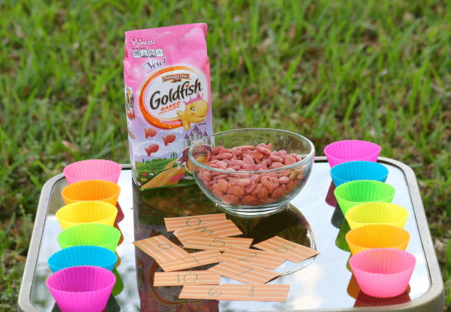 Making a counting game with cut papers and goldfish crackers and muffin liners