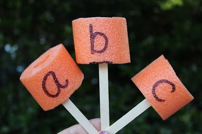 Alphabet obstacle courses pieces with pool noodles and popsicle sticks