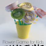 Colorful spiral paper flowers in yellow pot made by kids