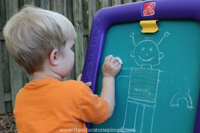 boy erasing robot arm