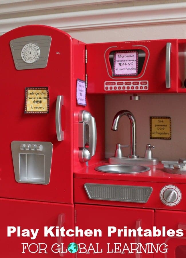 Red pretend play kitchen for kids with labels in 4 languages to include global learning into every day play.