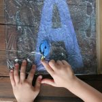 Child learning their Alphabet with hands-on Swimming Letters with Dory Sensory Bag