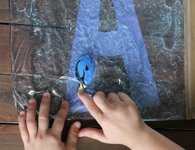 Child learning their Alphabet with hands-on Swimming Letters with Dory Sensory Bag