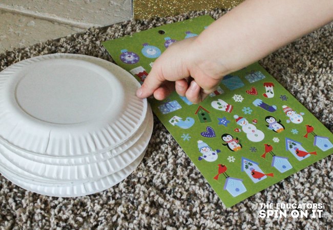 Drawing a paper plate letter card while playing Christmas Tree Alphabet Recognition Activity for Kids 