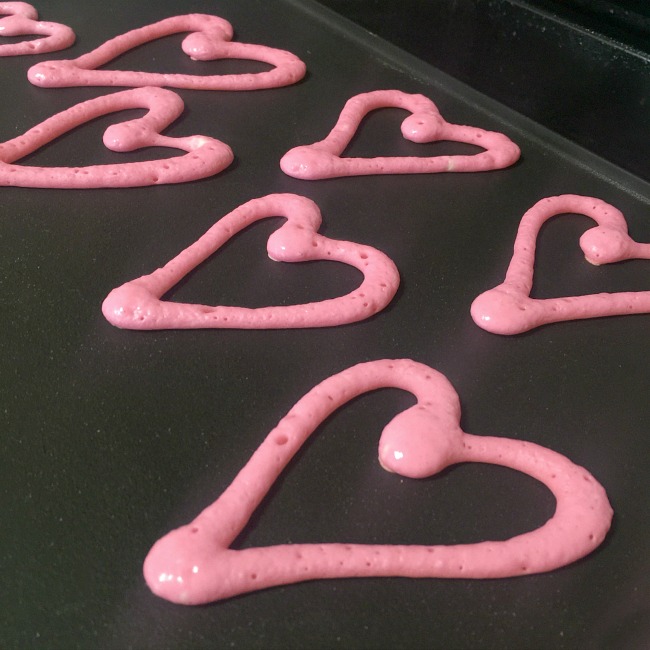 Making heart shaped pancakes for valentines day 