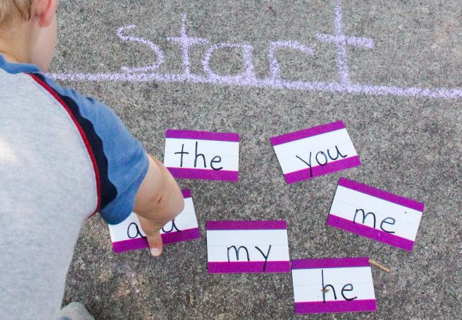 START! Child gets ready to play a sidewalk chalk sight word game