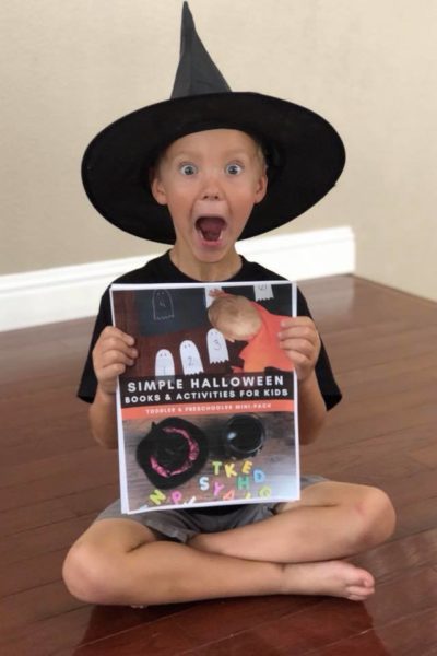 Boy with Witch Hat Holding Printable Halloween ebook for Preschoolers and Toddlers with Activities & Books