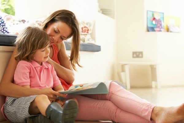 Mother reading a back to school book with their child