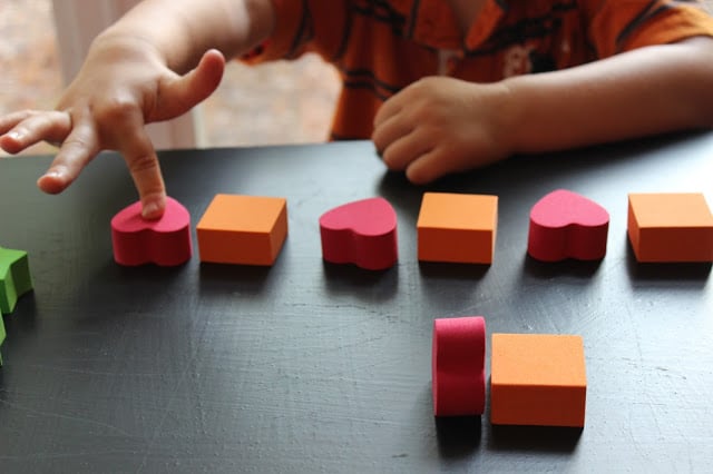 Patterning activity for preschoolers using red and orange foam shapes