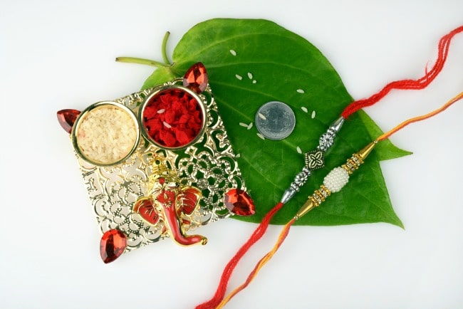 Display of items used for Raksha Bandhan with brother and sister. 