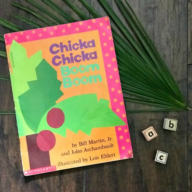 Book cover of the book Chicka Chicka Boom Boom with Coconut Tree and abc stamp blocks on Wooden floor with palm frawn.