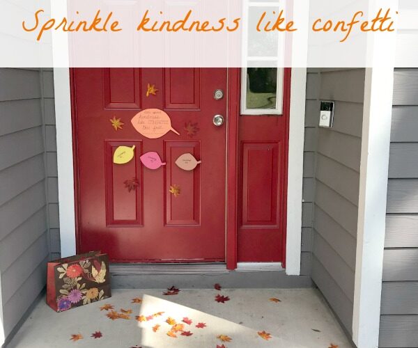 Front door covered with leaves for random act of kindness in fall