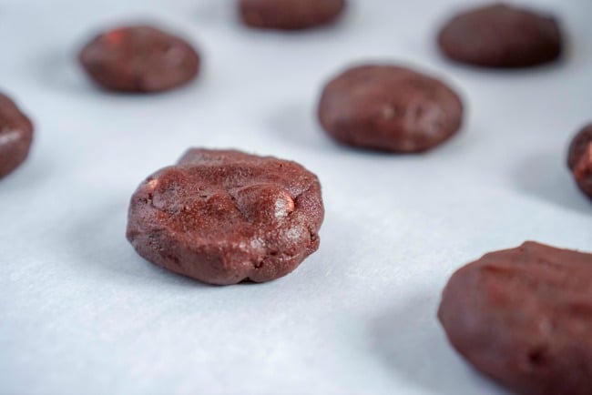 Hot chocolate cookie dough rounds on parchment paper