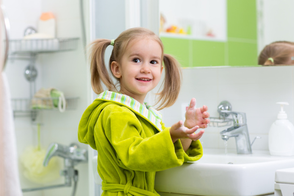 Child learning how to wash their hands