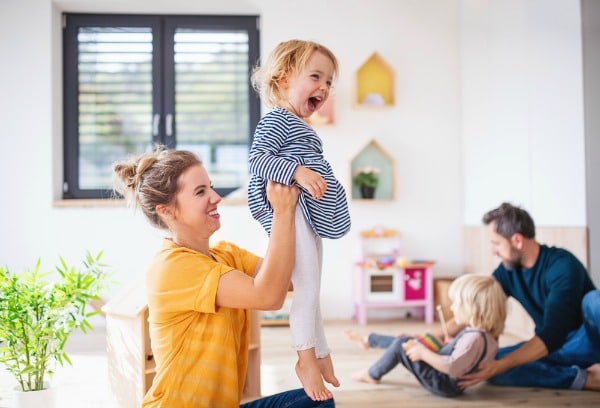 mother playing with daughter and father with son