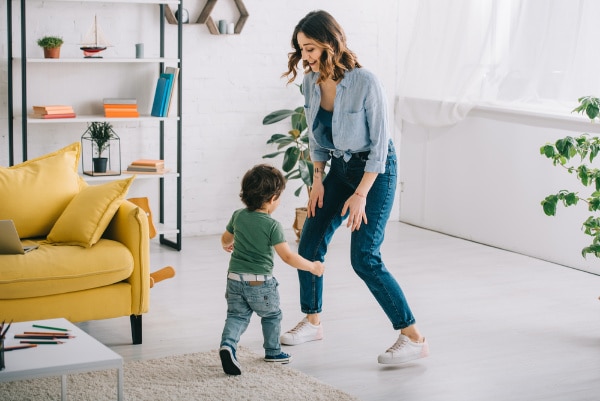 parent dancing with son in living room