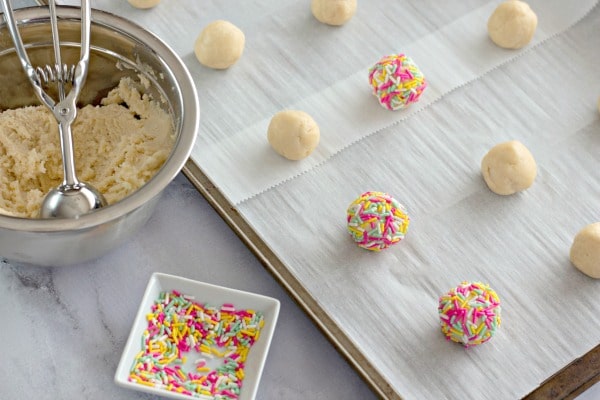Making dough balls for cream cheese sprinkle cookies