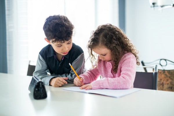 single parent support child at home at counter with school work