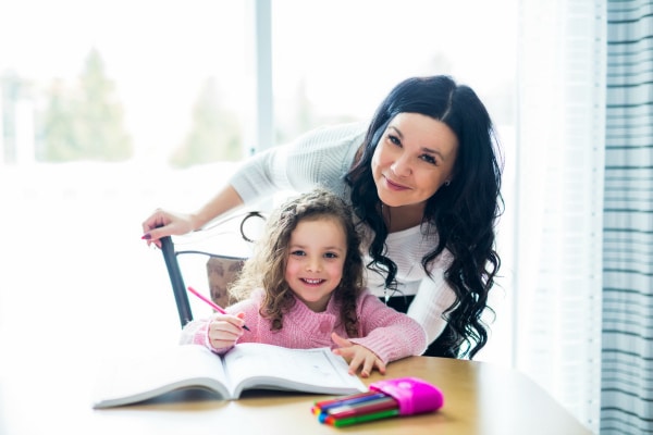 single parent support child at home at counter with school work