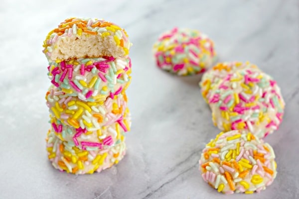 Cookies stacked with sprinkles on them