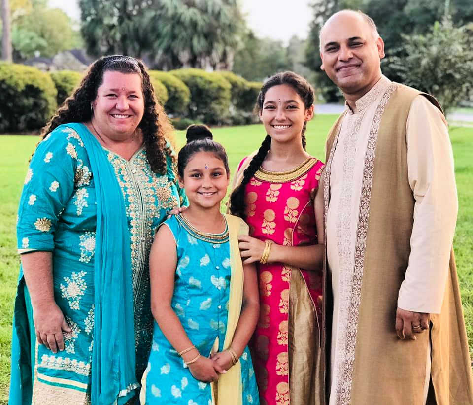 Family celebrating Diwali wearing traditional Indian clothing