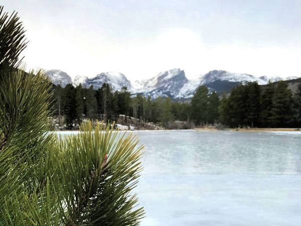 Frozen lake in Rocky mountains with mountains in backgroun