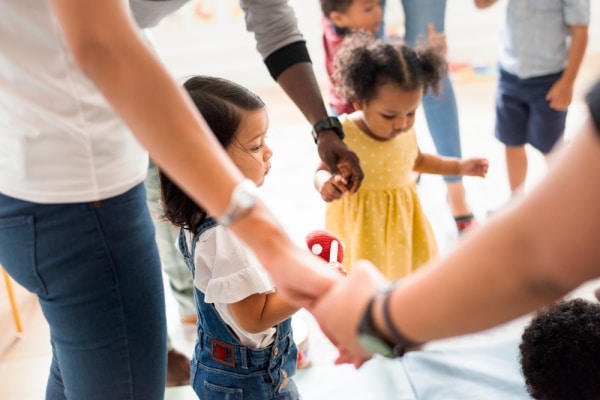 Parenting meeting for playgroup with kids holding hands