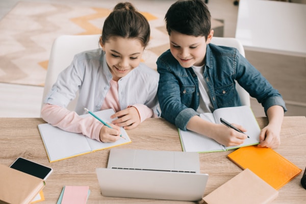 Two kids taking online class from Meetup