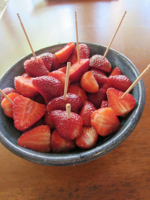 Picked Strawberries in pottery bowl with wooden skewers
