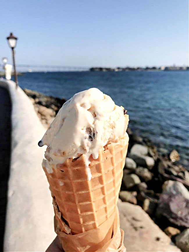Ice cream with waffle cone during summer fun along water front with bridge