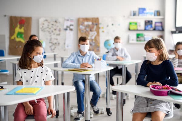 Students in classroom wearing masks to discuss resources and tips for protecting our children from COVID delta variant