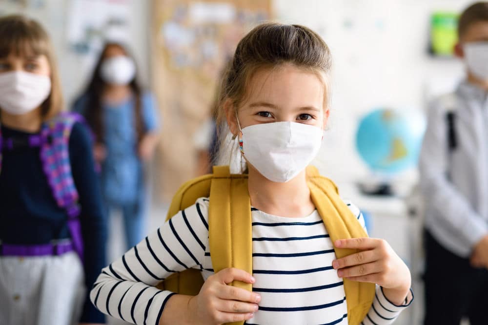 Children in school wearing a mask to learn more ways of how to protect our children in schools during Covid-19 Pandemic