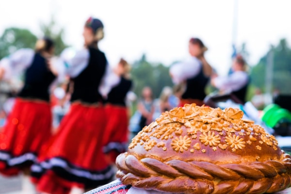 Ukrainian festive Loaf of Bread with Ukrainian dancers in background