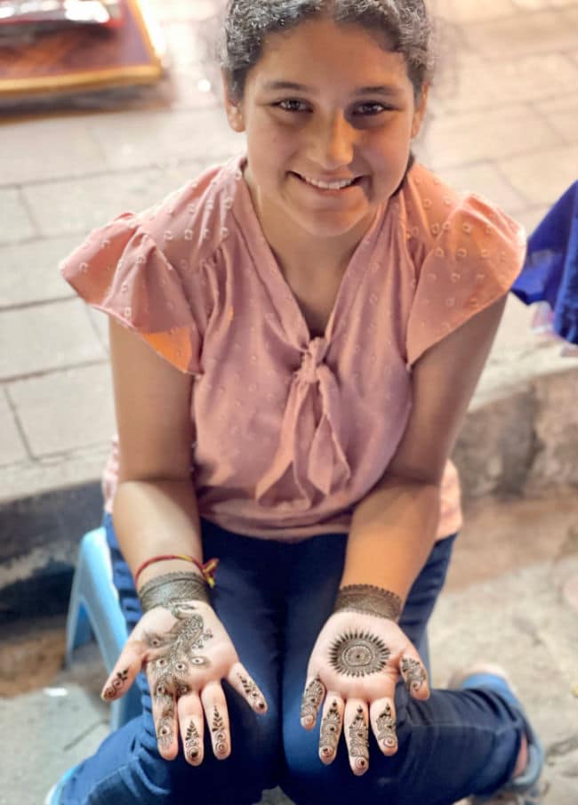 Getting Henna done in Lagput Nagar Market in New Delhi, India