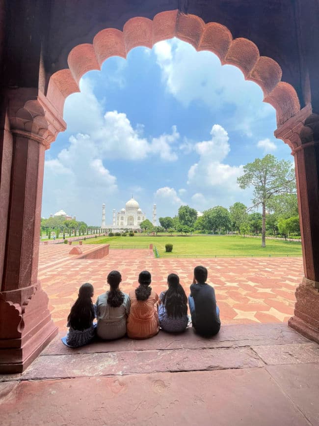 Children looking at Taj Mahal from a distance in Agra, India