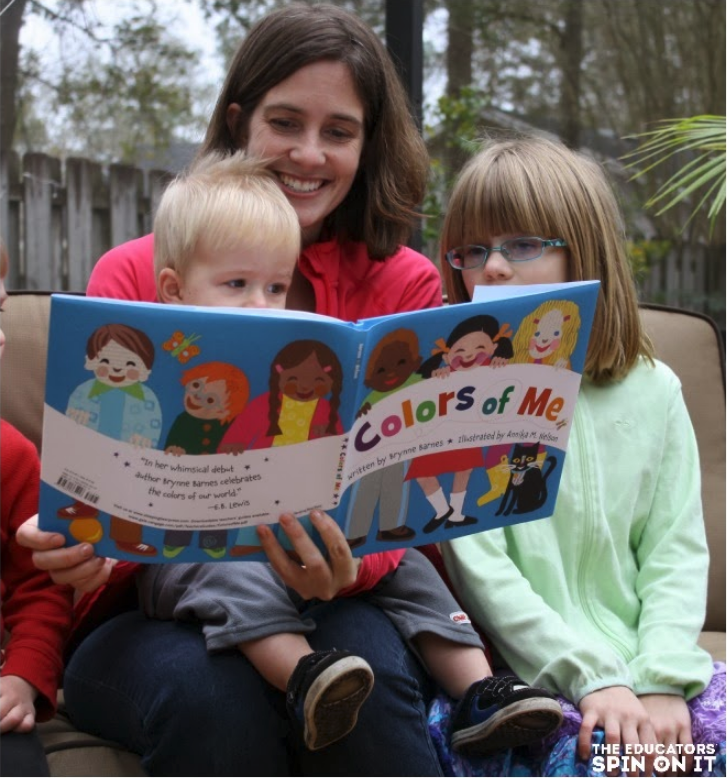 Mother reading book to children titled Colors of Me