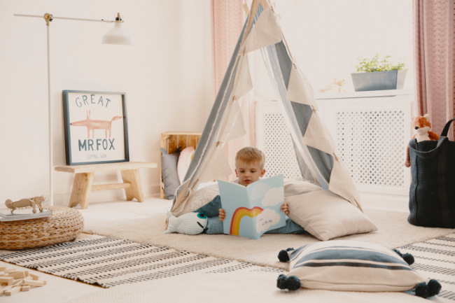 Child reading in a tent