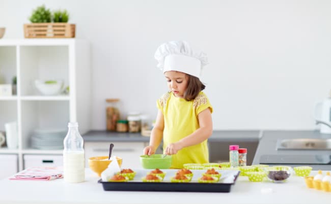 Child making muffins in the kitchen with easy to follow recipe 