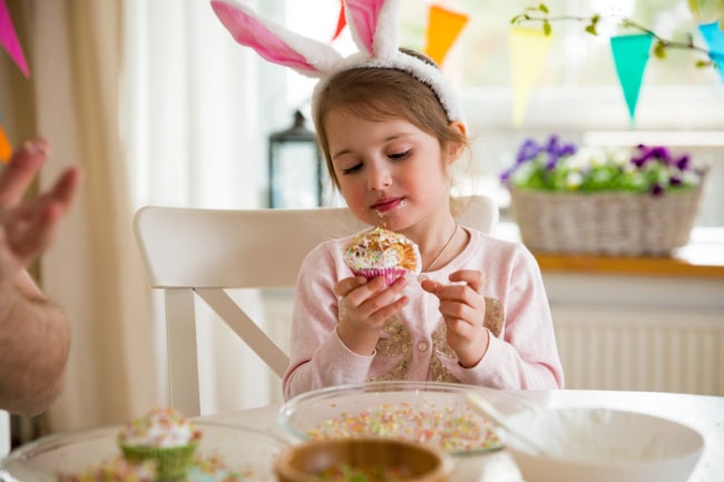 Child with Bunny Ears on eating Easter cupcake