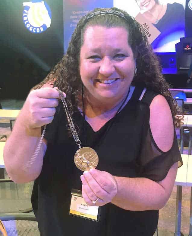 Kim Vij holding Olympic Gold Medal